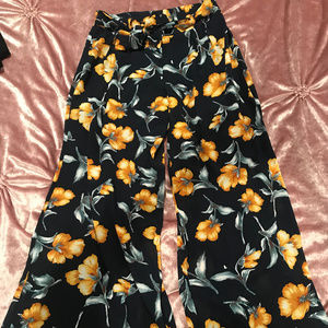 Navy blue bell bottoms with yellow flowers
